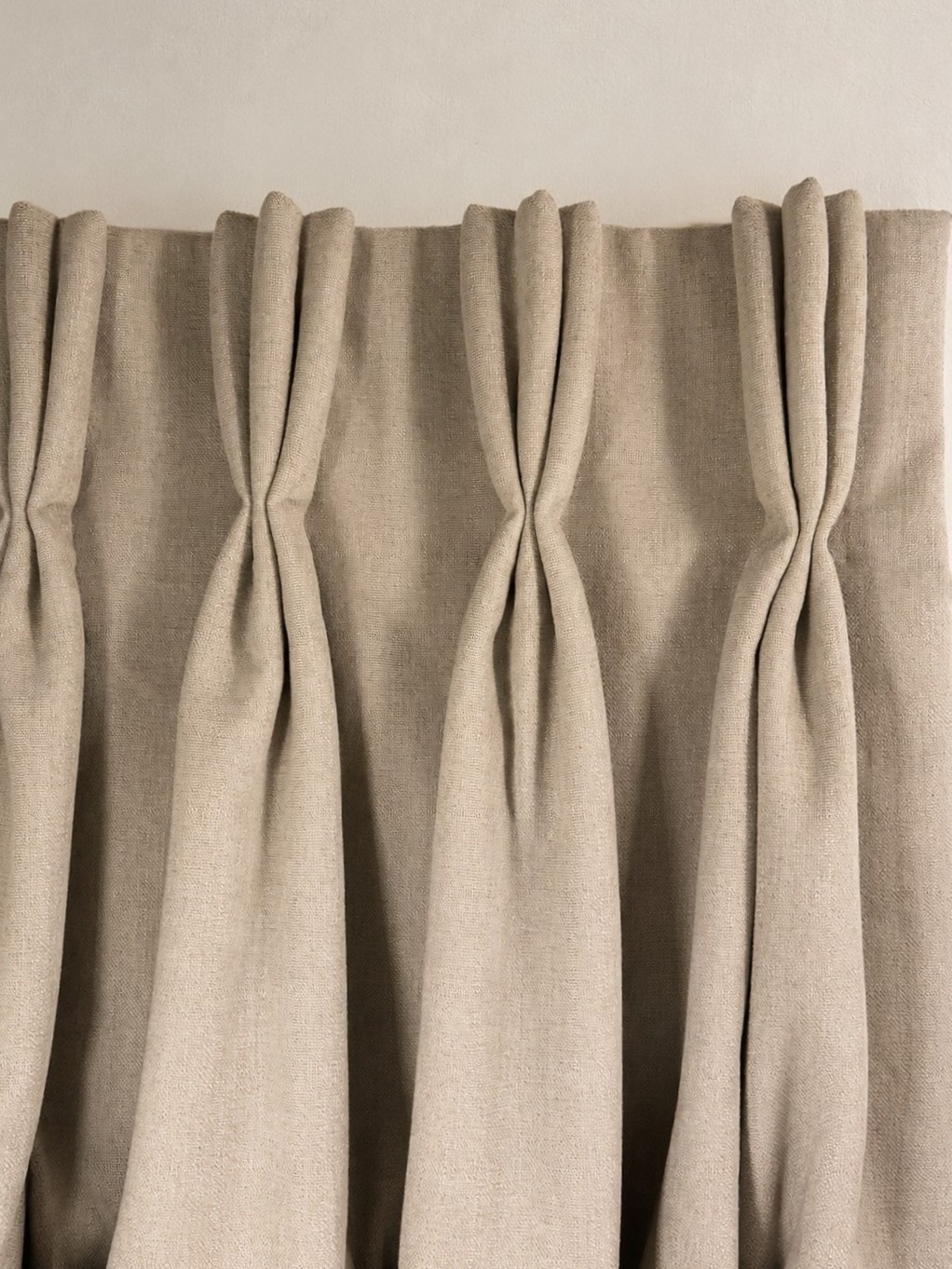 Triple French pleats in a natural linen curtain heading